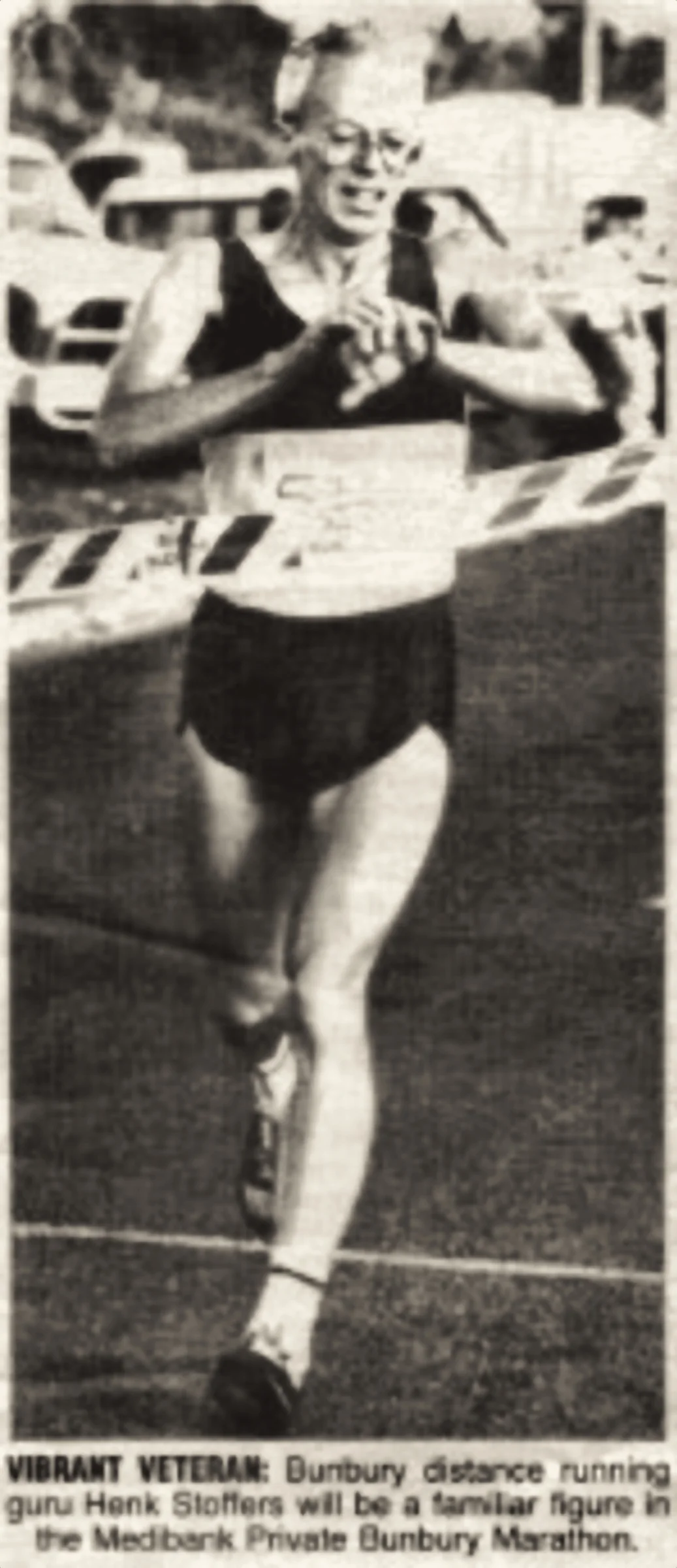 A newspaper clipping showing a veteran runner finishing, captioned about Henk Stoffers.