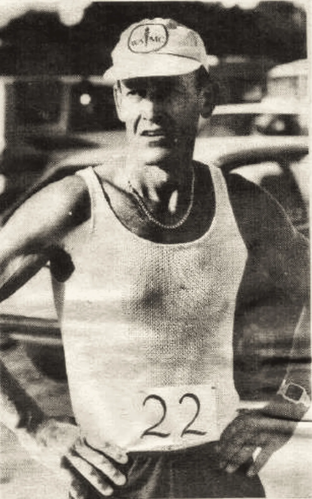 A runner in a WA Marathon Club cap wearing race number 22, mid-race.
